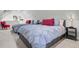 Twin bedroom with gray bedding, red pillows, and a small nightstand at 208 Sumter Ave, Summerville, SC 29483