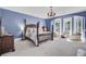 Primary bedroom with four poster bed and sitting area at 208 Sumter Ave, Summerville, SC 29483