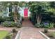 Brick walkway to a home's entrance with blooming hydrangeas at 208 Sumter Ave, Summerville, SC 29483