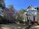 Charming two-story home with blooming magnolia tree in front at 208 Sumter Ave, Summerville, SC 29483