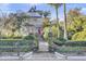 Two-story home with a red door, iron gate, and landscaped yard at 208 Sumter Ave, Summerville, SC 29483