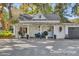 Charming white cottage with a covered porch and landscaping at 208 Sumter Ave, Summerville, SC 29483