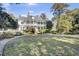 Elegant white home with a wrap around porch and lush landscaping at 208 Sumter Ave, Summerville, SC 29483