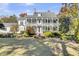 Elegant two-story home with a metal roof and well-manicured lawn at 208 Sumter Ave, Summerville, SC 29483