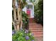 Red front door with brick steps and blooming hydrangeas at 208 Sumter Ave, Summerville, SC 29483