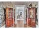Charming hallway with antique corner cabinets and floral wallpaper at 208 Sumter Ave, Summerville, SC 29483