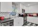 White kitchen with black and white tile floors at 208 Sumter Ave, Summerville, SC 29483