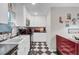 Bright kitchen features white cabinets, black countertops, and a retro diner theme at 208 Sumter Ave, Summerville, SC 29483