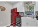 Retro-style kitchen with red refrigerator, white cabinets, and black and white checkered floor at 208 Sumter Ave, Summerville, SC 29483