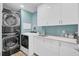 Bright laundry room with modern washer, dryer, and white cabinets at 208 Sumter Ave, Summerville, SC 29483