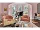 Sunlit living room with two pink armchairs and a grand piano at 208 Sumter Ave, Summerville, SC 29483