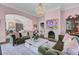 Living room with pink walls, fireplace, and velvet sofas at 208 Sumter Ave, Summerville, SC 29483