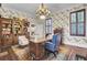 Home office with wooden desk, built-in shelving and blue chair at 208 Sumter Ave, Summerville, SC 29483