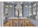 Outdoor kitchen features marble countertops, stainless steel appliances, and wicker barstools at 208 Sumter Ave, Summerville, SC 29483