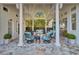 Covered patio with seating area, fire pit, and hanging swing at 208 Sumter Ave, Summerville, SC 29483