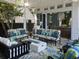 Covered patio with seating area, fire pit, and view into kitchen at 208 Sumter Ave, Summerville, SC 29483