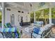 Covered patio with seating area, fire pit, and hanging swing at 208 Sumter Ave, Summerville, SC 29483