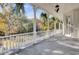Spacious front porch with white columns and view of garden at 208 Sumter Ave, Summerville, SC 29483