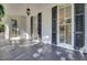 Side porch with dark gray wood floors and shutters at 208 Sumter Ave, Summerville, SC 29483