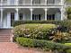 Classic white porch with intricate details and blooming azaleas at 208 Sumter Ave, Summerville, SC 29483