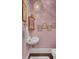 Stylish powder room with a gold framed mirror and pink walls at 208 Sumter Ave, Summerville, SC 29483
