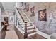 Elegant staircase with ornate banister and wall art at 208 Sumter Ave, Summerville, SC 29483