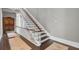 Grand staircase with dark wood and white railings at 208 Sumter Ave, Summerville, SC 29483