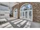 Sunroom with brick wall, arched windows, and pool view at 208 Sumter Ave, Summerville, SC 29483