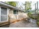 Quaint patio with seating area, umbrella, and exterior view of the house at 229 Plymouth Ave # 1, Charleston, SC 29412