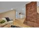 Spacious loft sitting area with exposed brick wall and hardwood floors at 230 Gordon St, Charleston, SC 29403