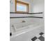 Bathroom with a large soaking tub, black and white tile, and a window at 2432 Hanscombe Point Rd, Johns Island, SC 29455