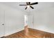 Bedroom with wood floors, ceiling fan and open door to bathroom at 2712 E Surrey Dr, North Charleston, SC 29405