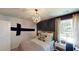 Cozy bedroom featuring a rustic wood accent wall and ample natural light at 302 Tiliwa St, Summerville, SC 29486