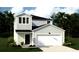 Two-story house with light gray siding, white trim, and a two-car garage at 302 Tiliwa St, Summerville, SC 29486