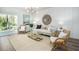 Living room with light walls, wicker furniture, and sliding glass doors at 302 Tiliwa St, Summerville, SC 29486