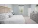 Spacious bedroom with light walls, large window, and carpeted floor at 302 Tiliwa St, Summerville, SC 29486