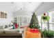 Bright sunroom with vaulted ceiling, wicker furniture, and a Christmas tree at 312 4Th Ave, Mount Pleasant, SC 29464