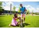 Couple with dog in a community lawn with modern buildings at 347 Trailmore Ln, Summerville, SC 29486