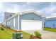 Attached garage with white door and gray siding at 347 Trailmore Ln, Summerville, SC 29486