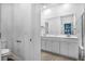 Double vanity bathroom with a large mirror and white cabinets at 356 Garden Lily Ln, Summerville, SC 29485