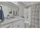 Modern bathroom with a white vanity, marble countertop, and a walk-in shower at 402 Corey Blvd, Summerville, SC 29483