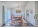 Dining room featuring sliding glass doors, a wooden dining table, and modern light fixture at 408 Trailway Dr, Summerville, SC 29483