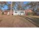 Landscaped backyard with mature trees and brick home at 41 Sorento Blvd, Hanahan, SC 29410