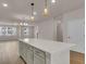 Modern kitchen island with white quartz countertops and light gray cabinets at 5138 Double Eagle Loop, Summerville, SC 29485