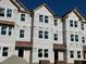 Three story townhome under construction, red roof, and brick accents at 5142 Double Eagle Lp, Summerville, SC 29485