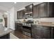 Modern kitchen featuring dark cabinetry, granite countertops, and stainless steel appliances at 593 Crossland Dr, Moncks Corner, SC 29461