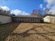 View of back of house, screened porch, and yard with autumn leaves at 7024 E Constellation Dr, North Charleston, SC 29418