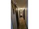 Long hallway with beige carpet and vertical striped wallpaper at 7024 E Constellation Dr, North Charleston, SC 29418