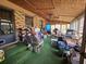 Large screened porch with green carpet and various items at 7024 E Constellation Dr, North Charleston, SC 29418