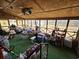 Screened porch with backyard view and various items at 7024 E Constellation Dr, North Charleston, SC 29418